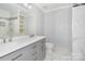 Nicely remodeled bathroom features a double vanity, tile floors, and shower at 5141 Grays Ridge Dr, Charlotte, NC 28269