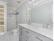 Modern bathroom features double vanity, a large mirror, and a marble-tiled shower with glass door at 5141 Grays Ridge Dr, Charlotte, NC 28269
