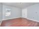 Bedroom featuring wood floor, neutral walls, window and closet at 5141 Grays Ridge Dr, Charlotte, NC 28269