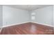Bedroom features wood flooring, neutral walls, and a window bringing in natural light at 5141 Grays Ridge Dr, Charlotte, NC 28269