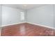 Bright bedroom features wood flooring, neutral walls, and natural light from a window at 5141 Grays Ridge Dr, Charlotte, NC 28269