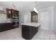Modern kitchen features stainless steel appliances, a center island, and tile floors at 5141 Grays Ridge Dr, Charlotte, NC 28269