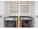 Laundry room includes washer, dryer, and shelving at 5141 Grays Ridge Dr, Charlotte, NC 28269