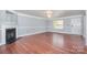 Open living room features a fireplace, chandelier, and hardwood floors at 5141 Grays Ridge Dr, Charlotte, NC 28269