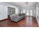 Cozy living room features hardwood floors, a modern ceiling fan, and ample natural light at 5141 Grays Ridge Dr, Charlotte, NC 28269