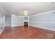 Spacious living room features a fireplace, wood floors, and a chandelier at 5141 Grays Ridge Dr, Charlotte, NC 28269