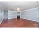 Open living room features a fireplace, chandelier, and hardwood floors at 5141 Grays Ridge Dr, Charlotte, NC 28269