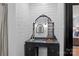 Charming bathroom with a vanity featuring an arched mirror and unique lighting fixtures at 5229 Mt Holly Huntersville Rd, Charlotte, NC 28216