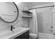 Bathroom features a sleek vanity, dark faucet, modern mirror, and patterned wallpaper at 5229 Mt Holly Huntersville Rd, Charlotte, NC 28216