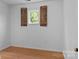 Bedroom boasts wood floors, fresh paint and a window with decorative wood shutters at 5229 Mt Holly Huntersville Rd, Charlotte, NC 28216