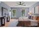 Serene bedroom with ample light, soft gray walls, and decorative wall art above the bed at 5229 Mt Holly Huntersville Rd, Charlotte, NC 28216