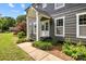 Charming home featuring a covered front door with white trim and well-maintained landscaping at 5229 Mt Holly Huntersville Rd, Charlotte, NC 28216