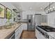 Bright kitchen with modern appliances, beautiful countertops, and stylish herringbone floors at 5229 Mt Holly Huntersville Rd, Charlotte, NC 28216