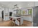 Modern kitchen features a large island, state-of-the-art appliances, and unique light fixture at 5229 Mt Holly Huntersville Rd, Charlotte, NC 28216