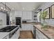 Bright kitchen with modern appliances, beautiful countertops, and stylish herringbone floors at 5229 Mt Holly Huntersville Rd, Charlotte, NC 28216