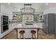 Modern kitchen features a large island, state-of-the-art appliances, and unique light fixture at 5229 Mt Holly Huntersville Rd, Charlotte, NC 28216