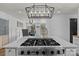 Modern kitchen features a large island with cooktop and unique light fixture at 5229 Mt Holly Huntersville Rd, Charlotte, NC 28216