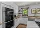 Bright kitchen with stainless steel appliances, beautiful countertops, and stylish herringbone floors at 5229 Mt Holly Huntersville Rd, Charlotte, NC 28216