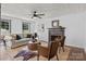 Living room with a fireplace, comfortable seating, and a decorative rug on herringbone floors at 5229 Mt Holly Huntersville Rd, Charlotte, NC 28216