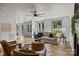 Bright living room featuring a ceiling fan, herringbone floors, and a decorative cowhide rug at 5229 Mt Holly Huntersville Rd, Charlotte, NC 28216