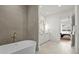Elegant bathroom with double vanities and a freestanding tub next to the open doorway to a bedroom at 536 Hillside Ave, Charlotte, NC 28209
