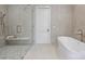 Stylish bathroom featuring a glass-enclosed shower, modern tub, and elegant fixtures at 536 Hillside Ave, Charlotte, NC 28209