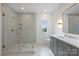 Well-lit bathroom featuring a glass enclosed shower, neutral tile, and a modern vanity with gold accents at 536 Hillside Ave, Charlotte, NC 28209