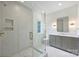 Well-lit bathroom featuring a glass enclosed shower, neutral tile, and a modern vanity with gold accents at 536 Hillside Ave, Charlotte, NC 28209
