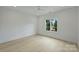 Bright and airy bedroom with light hardwood floors, a ceiling fan, and a large window with a view at 536 Hillside Ave, Charlotte, NC 28209