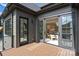 Outdoor deck overlooking a dining space with open sliding doors to kitchen at 536 Hillside Ave, Charlotte, NC 28209