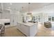 Open-concept kitchen featuring a large island, breakfast bar seating, and seamless transition to the dining and living areas at 536 Hillside Ave, Charlotte, NC 28209