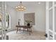 Bright home office featuring hardwood floors, a modern chandelier, a desk, and large window at 536 Hillside Ave, Charlotte, NC 28209