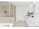 Bathroom featuring tub and shower combo, updated lighting, and vanity with storage space at 5630 Galloway Dr # 49, Stanfield, NC 28163