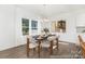 Elegant dining room with a modern chandelier, stylish chairs, and large windows at 5630 Galloway Dr # 49, Stanfield, NC 28163