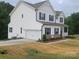 Charming two-story home with white siding, black shutters, attached garage, and a cozy front porch at 5630 Galloway Dr # 49, Stanfield, NC 28163