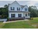 Beautiful two-story home featuring a modern farmhouse design and lush green lawn at 5630 Galloway Dr # 49, Stanfield, NC 28163
