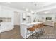 Well-lit kitchen showcasing a central island with bar stools and modern white cabinetry at 5630 Galloway Dr # 49, Stanfield, NC 28163