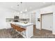 Modern kitchen with white cabinets, marble countertops, and a stylish island with seating at 5630 Galloway Dr # 49, Stanfield, NC 28163