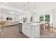 Open-concept kitchen with island overlooking a spacious living area with hardwood floors at 5630 Galloway Dr # 49, Stanfield, NC 28163