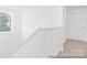 An upstairs stairwell with white walls and neutral carpeted stairs at 5630 Galloway Dr # 49, Stanfield, NC 28163