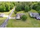 An aerial view of a charming single-Gathering home with well-maintained landscaping and a detached garage at 5678 Cedar Run Dr, Denver, NC 28037