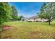 View of spacious backyard, trees and screened porch area, perfect for entertaining at 5678 Cedar Run Dr, Denver, NC 28037