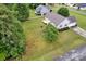 A verdant backyard featuring mature trees, lush lawn, and a cozy back deck, ideal for outdoor relaxation at 5678 Cedar Run Dr, Denver, NC 28037