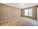 Bedroom featuring neutral carpet, paint, ceiling fan, and a window for natural light at 5678 Cedar Run Dr, Denver, NC 28037