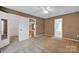 Spacious carpeted bedroom with open closet and attached bathroom for convenience and accessibility at 5678 Cedar Run Dr, Denver, NC 28037