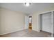 Bedroom features neutral carpet, an open closet, and a doorway to a bathroom at 5678 Cedar Run Dr, Denver, NC 28037