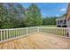 An outside deck overlooks a large backyard surrounded by large trees at 5678 Cedar Run Dr, Denver, NC 28037