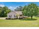 Charming single-story home with manicured lawn, mature tree, and covered front porch at 5678 Cedar Run Dr, Denver, NC 28037