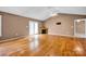 Spacious living room featuring hardwood floors, fireplace, ceiling fan, and lots of light at 5678 Cedar Run Dr, Denver, NC 28037