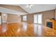 Spacious living room featuring hardwood floors, fireplace, ceiling fan, and vaulted ceilings at 5678 Cedar Run Dr, Denver, NC 28037